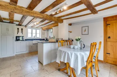 a kitchen and dining room with a table and chairs at 5 Bed in Finningham oc-obhf in Finningham