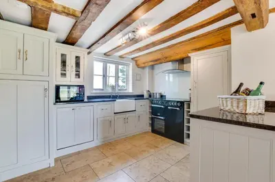 a kitchen with white cabinets and black appliances at 5 Bed in Finningham oc-obhf in Finningham