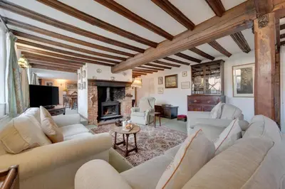 a living room with a couch and a fireplace at 4 Bed in Orford oc-obh2 in Orford