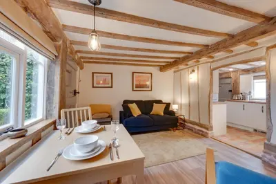 a living room with a table and a couch at 2 Bed in Saxtead oc-pera in Saxtead