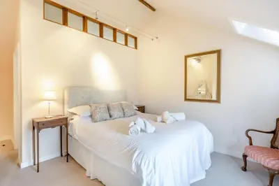a bedroom with a bed and a mirror and a chair at 2 Bed in Yoxford oc-hploug in Yoxford