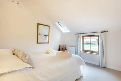 a white bed in a room with a window at 2 Bed in Yoxford oc-hploug in Yoxford