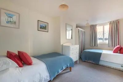 a bedroom with two beds with red and blue pillows at 3 Bed in Aldeburgh oc-reg in Aldeburgh