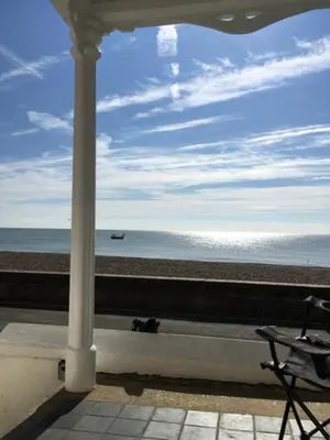 a view of the beach from a balcony with a chair at 3 Bed in Aldeburgh oc-reg in Aldeburgh