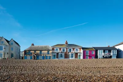 a row of colorful houses on a beach at 3 Bed in Aldeburgh oc-reg in Aldeburgh