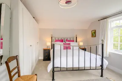 a bedroom with a bed with pink pillows at 2 Bed in Saxmundham oc-rvr in Snape