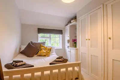 a bedroom with a bed with pillows and a window at 2 Bed in Saxmundham oc-rvr in Snape