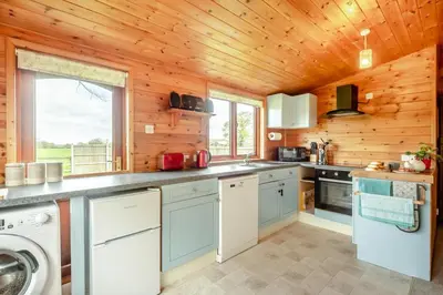 a kitchen with wooden walls and a wooden ceiling at 2 Bed in Otley oc-slm in Burgh
