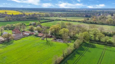 an aerial view of a green field with houses and trees at 2 Bed in Otley oc-slm in Burgh