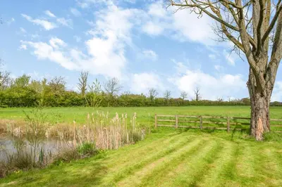 a tree in a field with a fence and a tree at 2 Bed in Otley oc-slm in Burgh