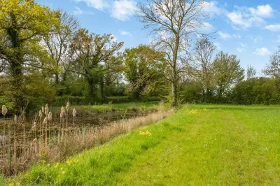 a field of grass with trees and a fence at 2 Bed in Otley oc-slm in Burgh