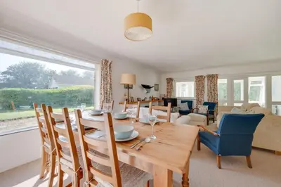 a dining room and living room with a table and chairs at 3 Bed in Aldeburgh oc-spr in Aldeburgh