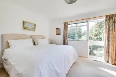 a white bedroom with a large bed and a window at 3 Bed in Aldeburgh oc-spr in Aldeburgh