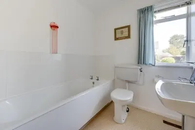 a white bathroom with a toilet and a sink at 3 Bed in Aldeburgh oc-spr in Aldeburgh