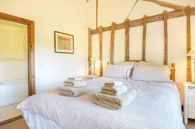 a room with a bed with towels on it at 3 Bed in All Saints South Elmham oc-sfspw in Saint James