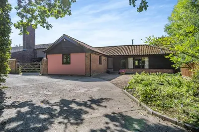 a brick house with a pink garage at 3 Bed in All Saints South Elmham oc-sfspw in Saint James