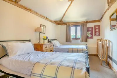 a bedroom with two beds and a window at 3 Bed in All Saints South Elmham oc-sfspw in Saint James