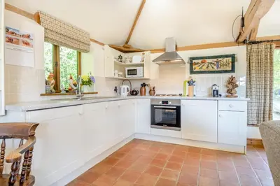 a kitchen with white cabinets and a tile floor at 3 Bed in All Saints South Elmham oc-sfspw in Saint James