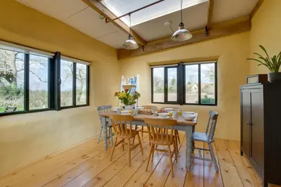 a dining room with a wooden table and chairs at 2 Bed in Haughley oc-strb in Haughley