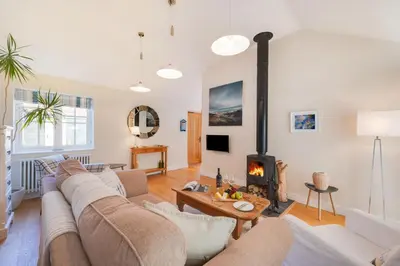 a living room with a couch and a fireplace at 2 Bed in Eye oc-slo in Wilby