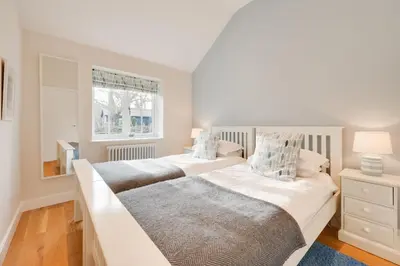 two beds in a white bedroom with a window at 3 Bed in Wilby oc-slowlo in Wilby