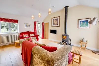 a living room with a couch and a fireplace at 3 Bed in Wilby oc-slowlo in Wilby