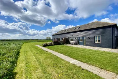 a barn with a grassy yard in front of it at 2 Bed in Newton oc-swro in Sudbury