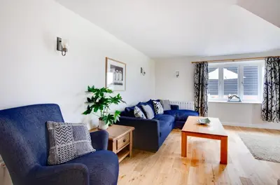 a living room with blue couches and a table at 2 Bed in Newton oc-swro in Sudbury