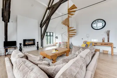 a living room with a large couch and a table at 4 Bed in Thorpeness oc-cho in Thorpeness