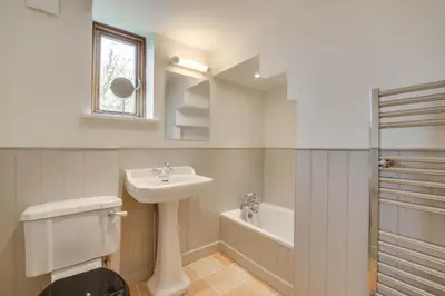 a bathroom with a sink and a toilet and a tub at 3 Bed in Debenham oc-thefol in Debenham
