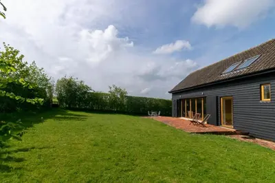 a large yard next to a house with a building at 3 Bed in Debenham oc-thefol in Debenham
