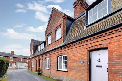 a brick house with a white door on a street at 2 Bed in Orford oc-sflpo in Orford