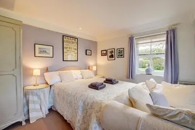 a bedroom with two beds and a couch at 2 Bed in Snape oc-sfoms in Snape