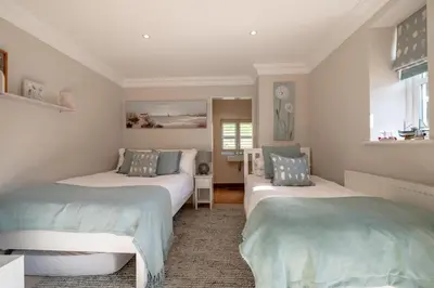 a bedroom with two beds and a window at 5 Bed in Orford oc-pav in Orford