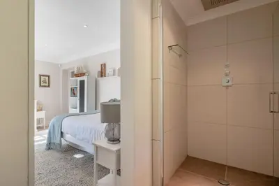 a bedroom with a bed and a glass shower at 5 Bed in Orford oc-pav in Orford