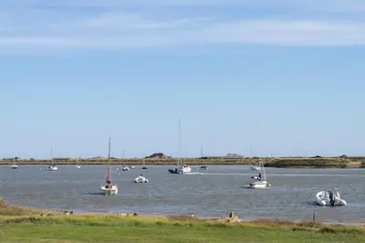 a group of boats sitting in the water at 5 Bed in Orford oc-pav in Orford