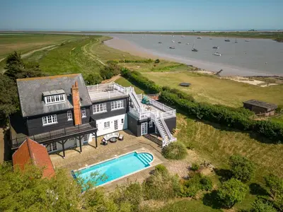 an aerial view of a house with a swimming pool at 5 Bed in Orford oc-pav in Orford