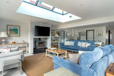 a living room with blue couches and a tv at 4 Bed in Aldeburgh oc-12lr in Aldeburgh