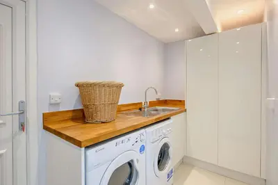 a laundry room with a washing machine and a sink at 4 Bed in Aldeburgh oc-12lr in Aldeburgh