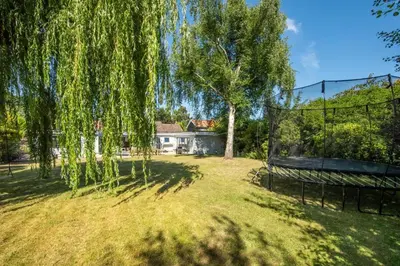 a park with a bench and trees and a house at 4 Bed in Aldeburgh oc-12lr in Aldeburgh