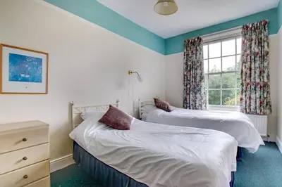two twin beds in a room with a window at 13 Bed in Tattingstone oc-tat26 in Tattingstone