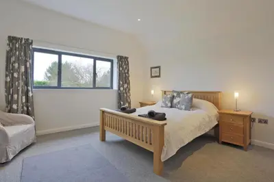 a bedroom with a large bed and a window at 2 Bed in Leiston oc-cqa in Theberton