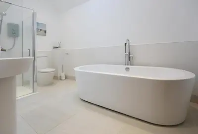 a white bathroom with a tub and a sink at 2 Bed in Leiston oc-cqa in Theberton