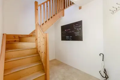 a staircase in a house with a chalkboard on the wall at 2 Bed in Woodbridge oc-vav in Hollesley