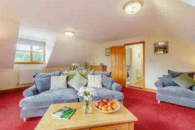 a living room with two blue couches and a table at 2 Bed in Woodbridge oc-vav in Hollesley