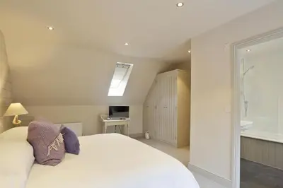 a bedroom with a white bed and a window at 2 Bed in Thorpeness oc-vels in Thorpeness