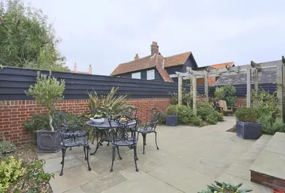 a patio with a table and chairs and a fence at 2 Bed in Thorpeness oc-vels in Thorpeness