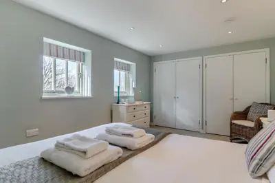 a bedroom with a bed with towels on it at 3 Bed in Knodishall oc-wbco in Aldringham