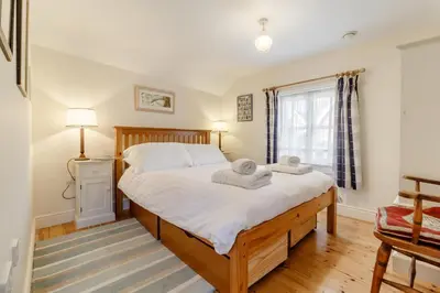 a bedroom with a bed with two towels on it at 3 Bed in Woodbridge oc-h23 in Woodbridge