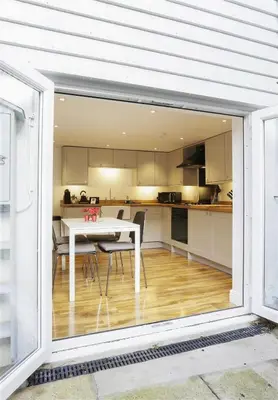 a kitchen with a white table and a table and chairs at 2 Bed in Aldeburgh oc-tsc in Aldeburgh